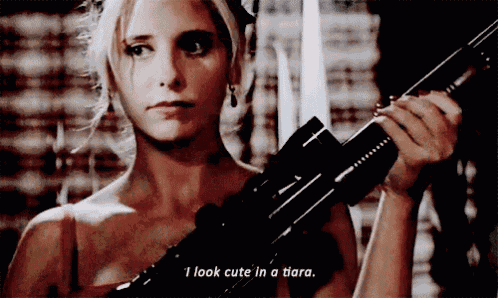 a woman is holding a gun and says i look cute in a tiara