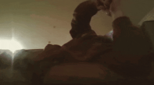 a blurry photo of a man laying on a bed