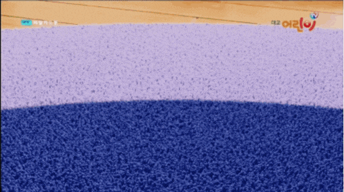 a blue and purple carpet with a tv logo on the bottom right