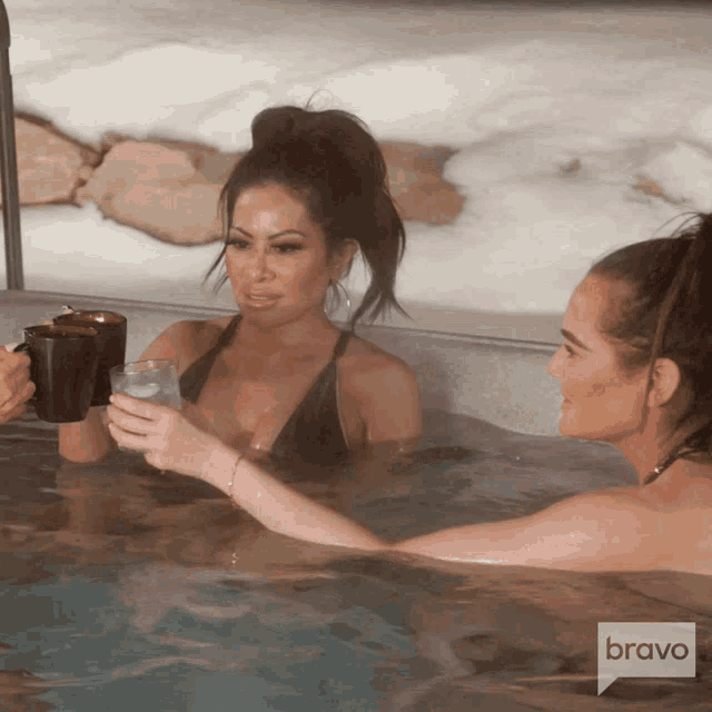 two women in a hot tub with a bravo logo on the bottom right
