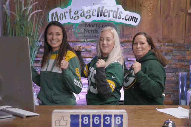a group of women standing in front of a mortgage nerds.com sign