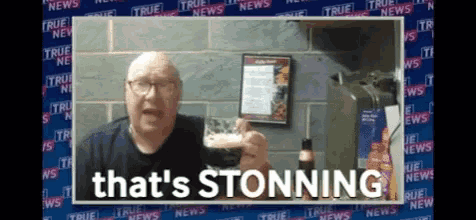 a man says that 's stonning in front of a wall with true news written on it