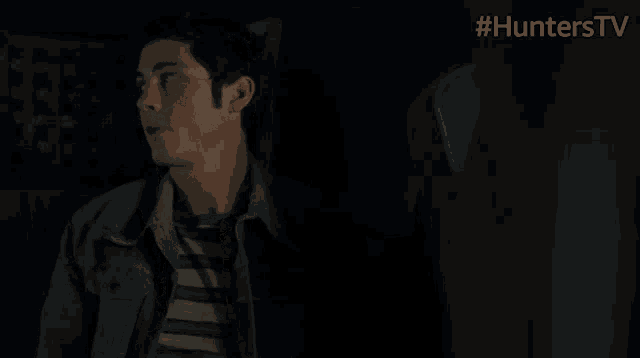 a man sitting in a dark room with #hunterstv written on the bottom right