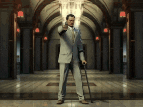 a man in a suit is holding a cane and pointing a gun in a hallway