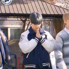 a boy in a varsity jacket with the number 20 on it