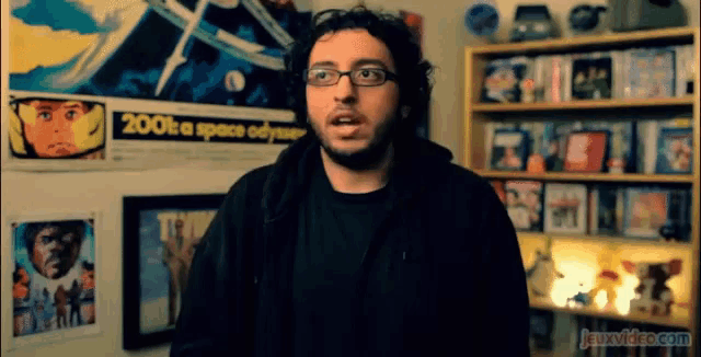 a man is standing in front of a poster that says 2001 a space odyssey