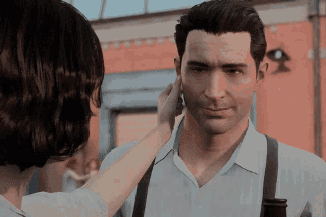 a woman touching a man 's ear in a video game