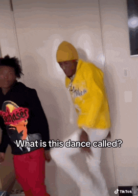 a man in a yellow hoodie is standing next to another man in red pants and asking what is this dance called .