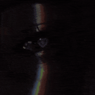 a close up of a woman 's eye with a rainbow behind it and the words meyline
