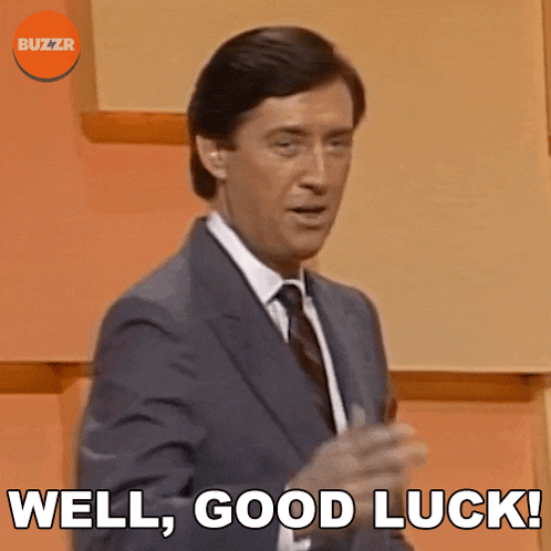 a man in a suit and tie is saying " well good luck "
