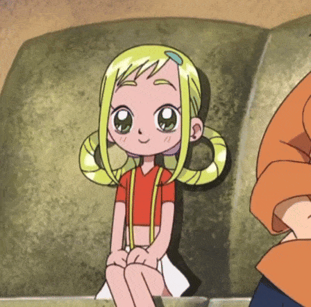 a little girl with blonde hair is sitting on a rock .
