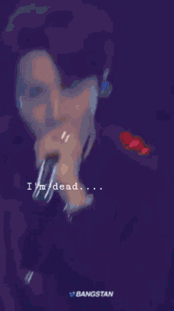 a blurry picture of a man with the words " i 'm dead " on the bottom