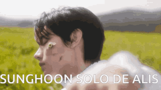 a young man with a flower on his face and the words sunghoon solo de alis