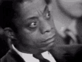 a black and white photo of a man in a suit and tie .