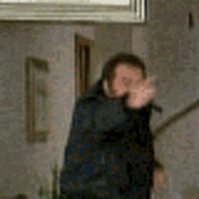 a man is standing on a set of stairs holding a gun .