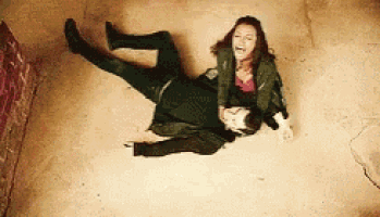 a man and a woman are laying on the floor .