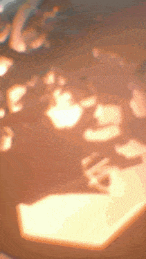 a blurred image of a stop sign with a shadow on the floor