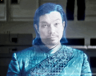 a man with long hair and a beard is being projected on a computer screen .