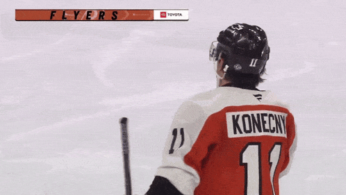 a hockey player wearing a number 11 jersey