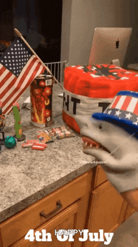 a 4th of july greeting with a shark puppet on the counter
