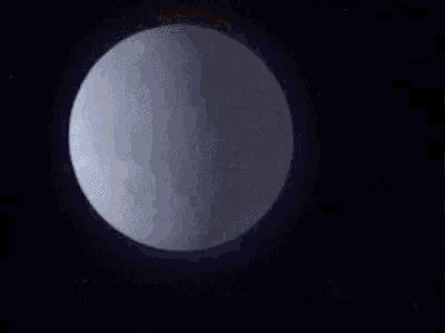 a full moon is visible through a telescope in the dark night sky .