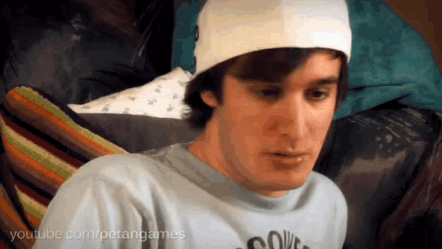 a man wearing a hat and a t-shirt that says youtube.com