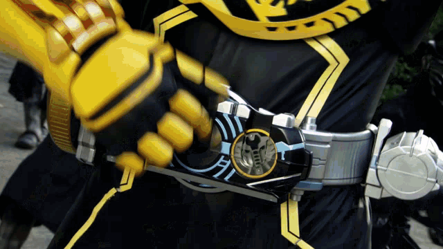 a person wearing a black and yellow costume with a belt that says ' samurai ' on it