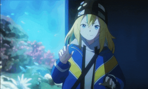 a girl with blonde hair and a black hat is standing in front of an aquarium