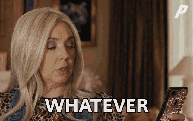 a woman in a leopard print dress is holding a cell phone and says whatever
