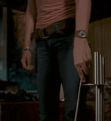a man in handcuffs is holding a stick in his hands