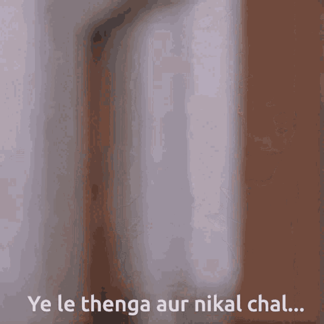 a blurred image with the words ye le thenga aur nikal chal written below it
