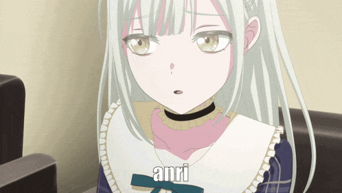 a girl with white hair is sitting in a chair and says anri