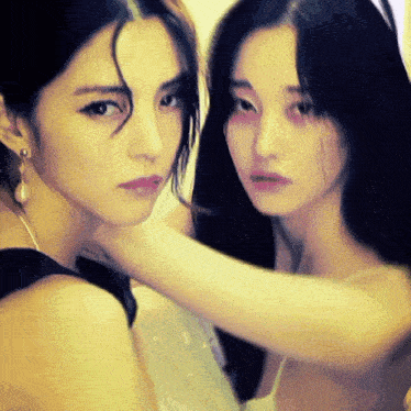 two women with long hair are posing for a picture