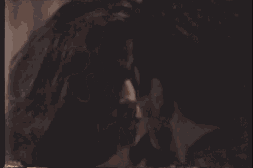 a close up of a man 's face smoking a cigarette .