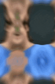 a blurry picture of a person 's face with a blue background