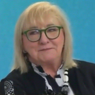 a close up of a woman wearing glasses and a scarf .