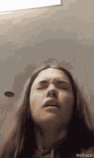 a woman making a funny face with her eyes closed