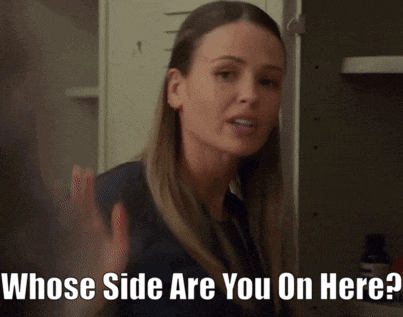 a woman is standing in front of a locker and says whose side are you on here