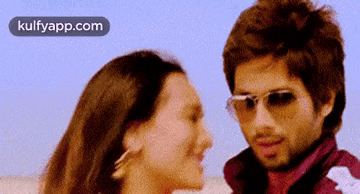 a man and a woman wearing sunglasses are looking at each other ..