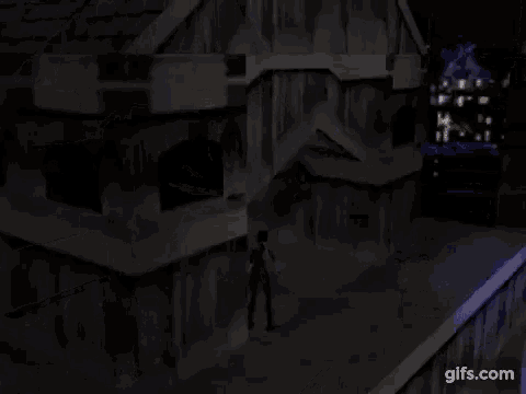 a person is standing on the roof of a building at night with a city in the background .