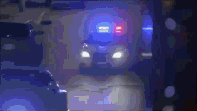 a blurry picture of a police car with blue lights