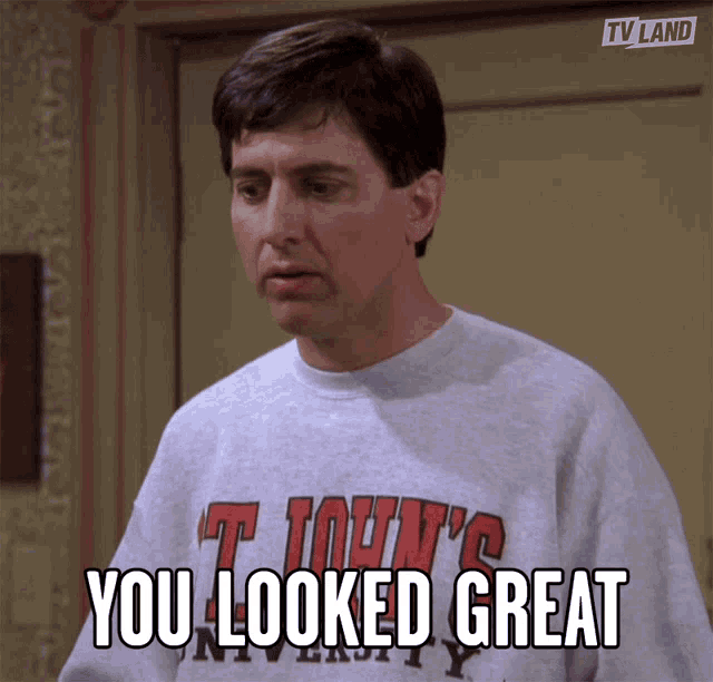 a man wearing a sweatshirt that says you looked great on it