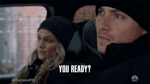 a man and a woman are sitting in a car and the man is saying you ready