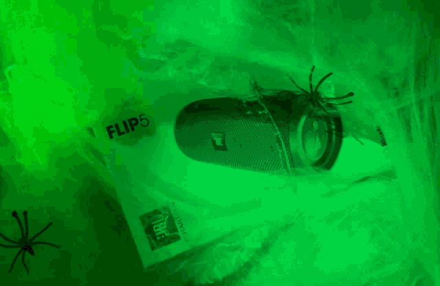 two spiders are crawling on a jbl flip5 speaker