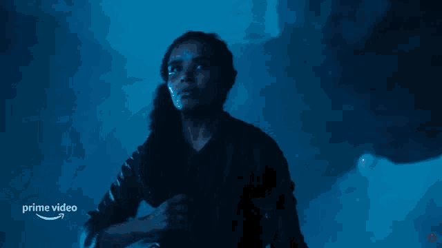 a man in a dark room with the words prime video on the bottom right