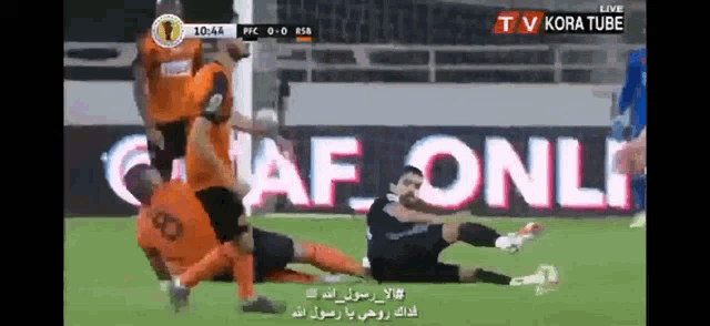 a soccer game is being played in front of a sign that says kora tube