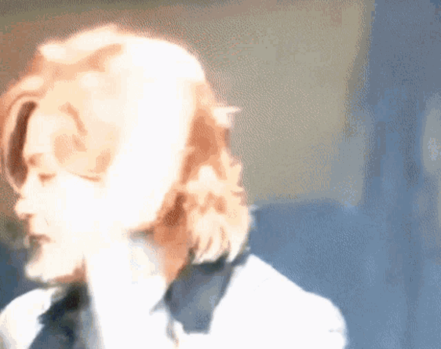 a blurry picture of a woman 's face with red hair