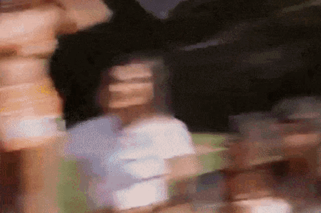 a blurry picture of a woman in a white dress