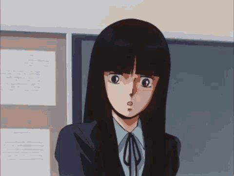 a girl with long black hair is standing in front of a bulletin board