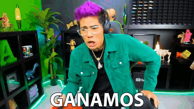 a man with purple hair is wearing headphones and a green jacket with the words ganamos written on it